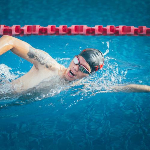 Young man performing sidestroke swim